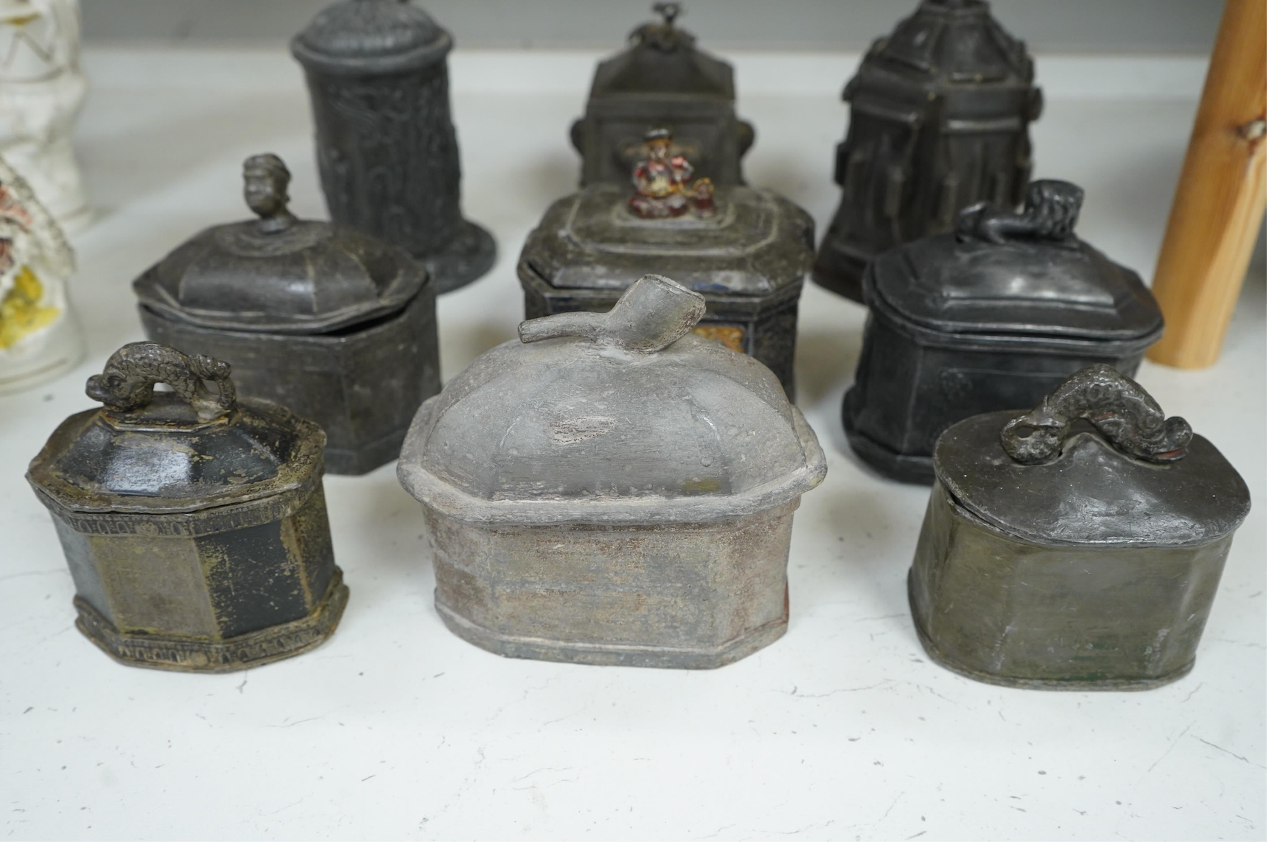 A collection of ten early 19th century lead tobacco boxes to include an octagonal example with remains of paintwork, largest 19cm high